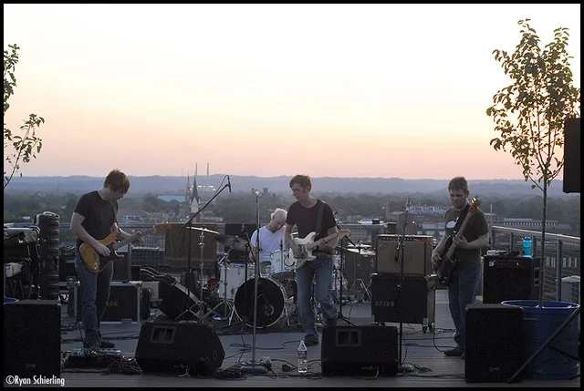 Full-band rooftop performance frame. EXIF camera time 2007-06-11 18:09:28; inferred ~9:09 PM Louisville local.
